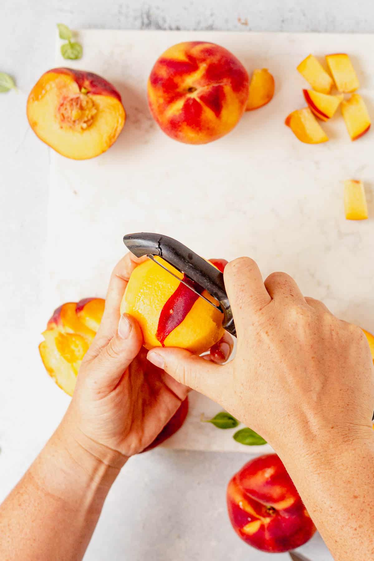 removing peach skin with a vegetable peeler