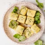 frozen basil and oil ice cubes on a plate
