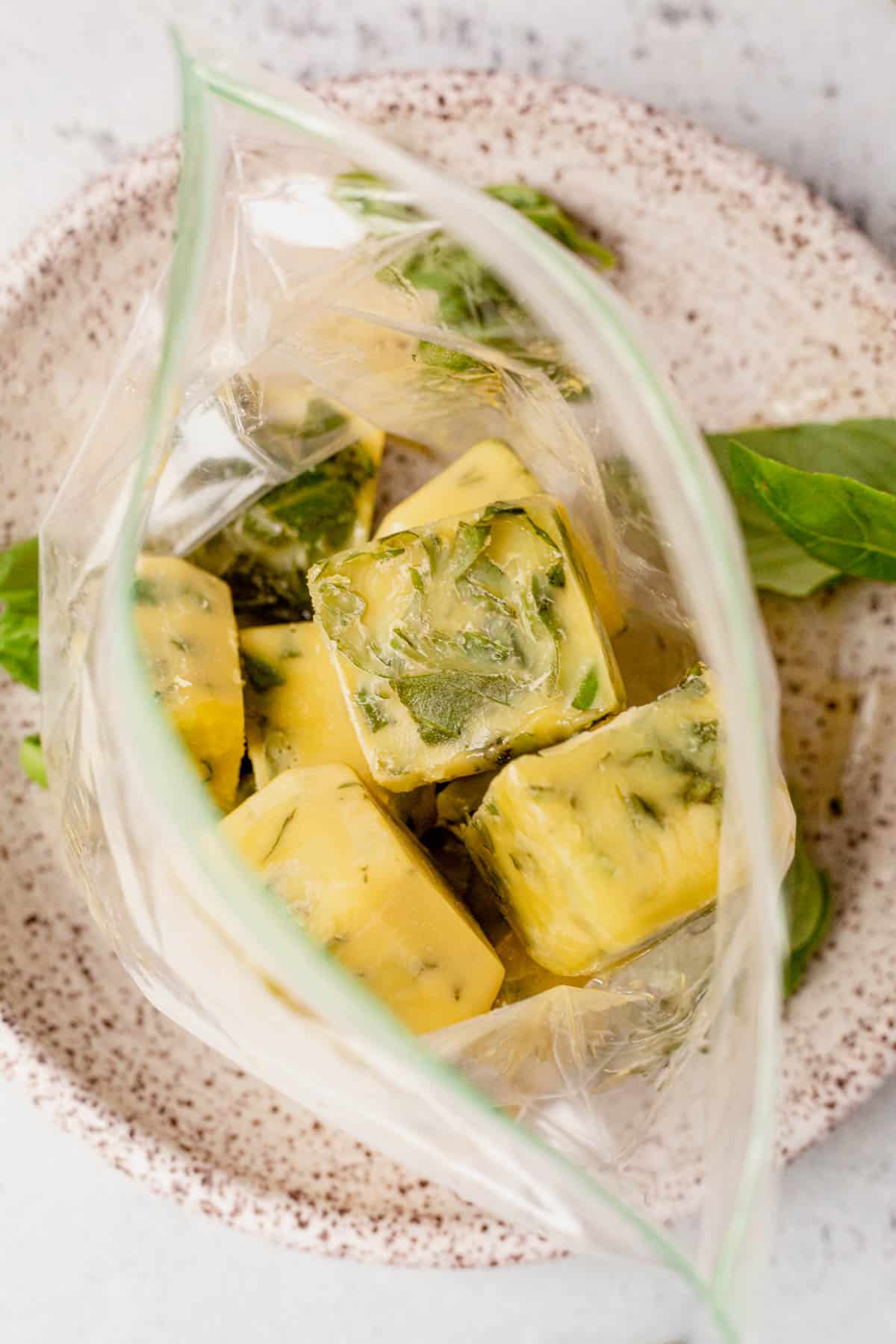 frozen basil and oil ice cubes in plastic bag