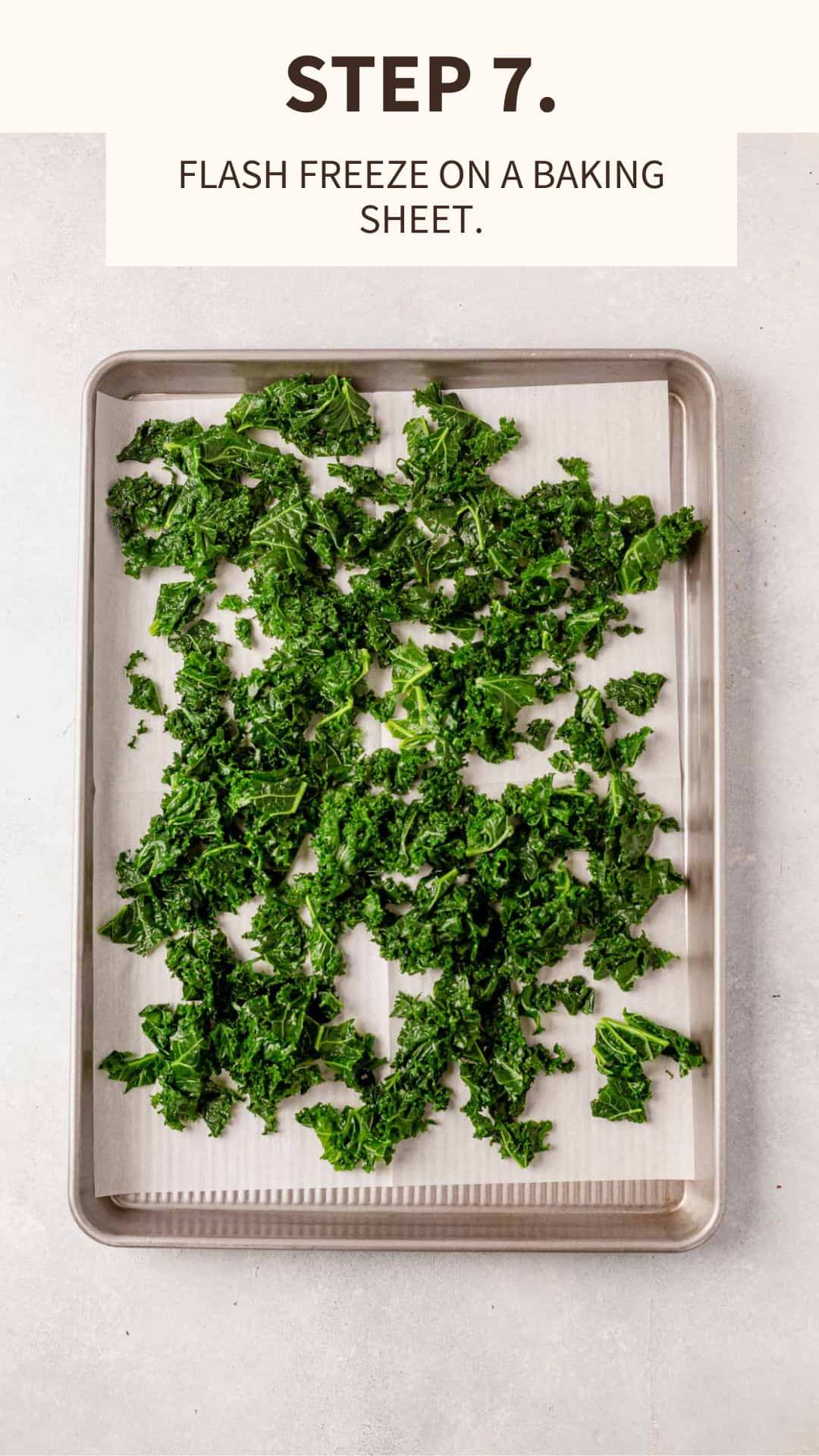kale laying on a cookie sheet to be flash frozen