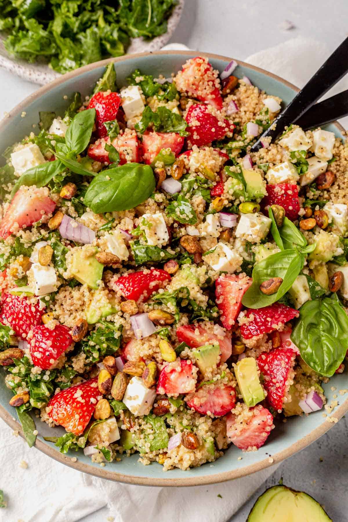 a large bowl of strawberry quinoa salad with feta