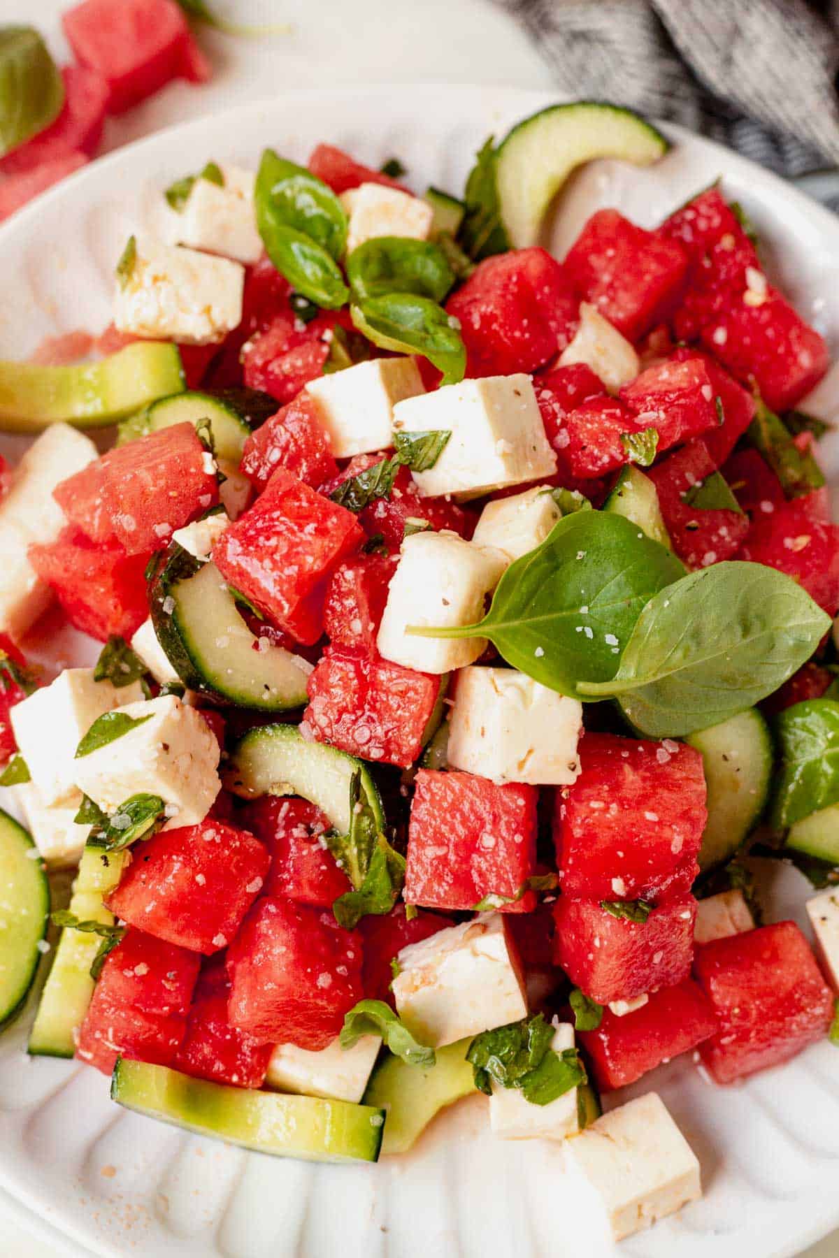 a plate full of watermelon feta salad with basil