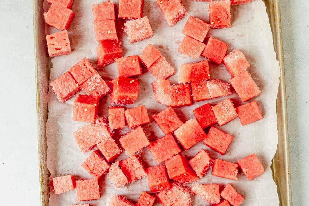 frozen watermelon chunks on a sheet pan