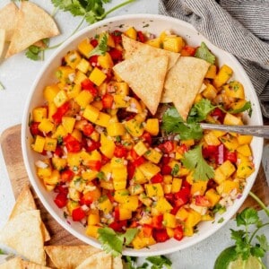 a bowl of peach mango salsa with chips