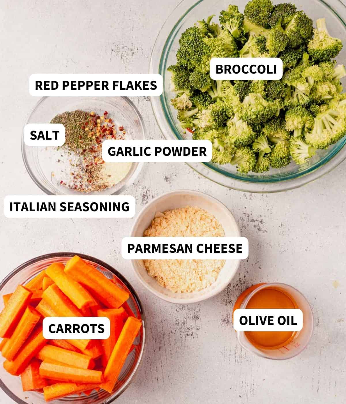 carrots, broccoli, italian seasoning, and parmesan cheese on a counter