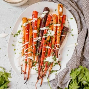 roasted rainbow carrots on a platter with parsley