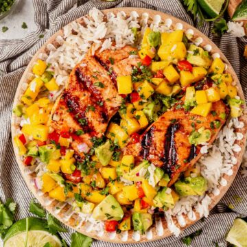 a bowl of rice with grilled salmon and mango salsa