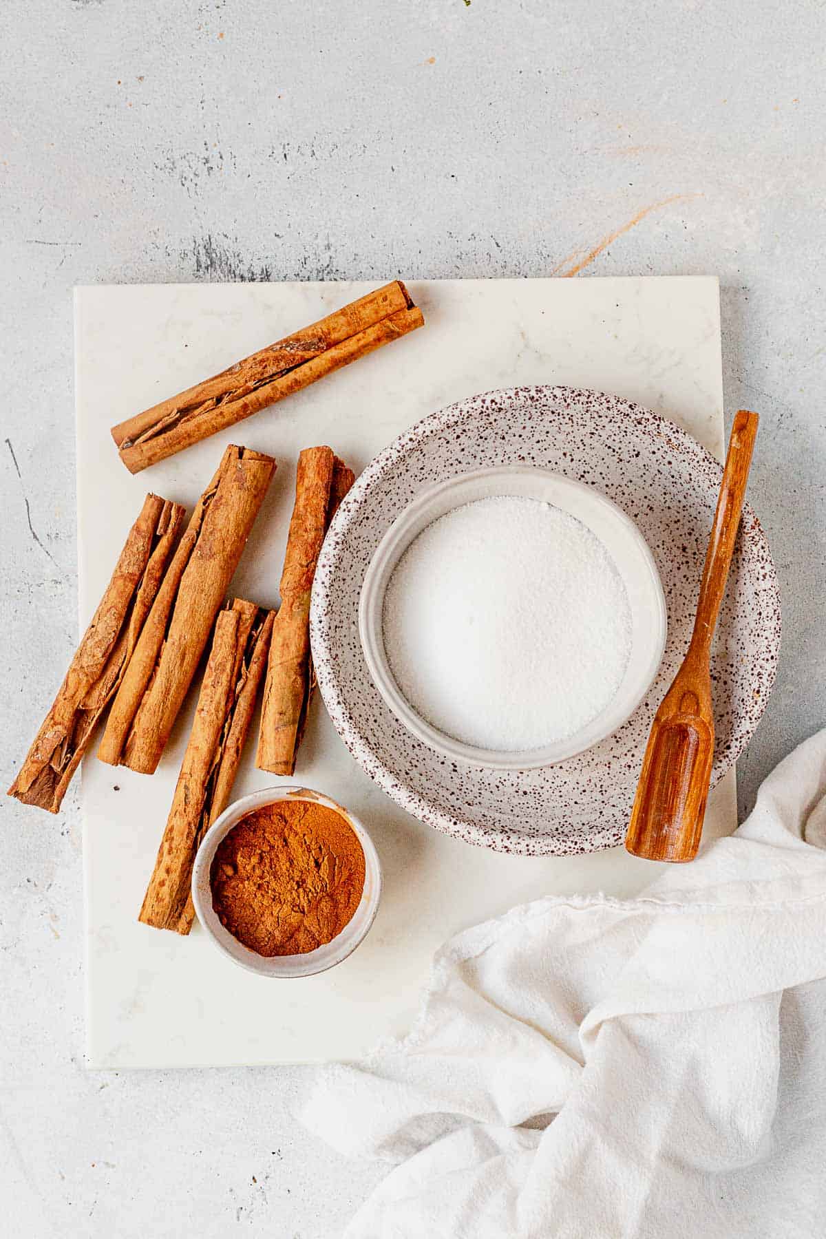 a bowl of cinnamon and a bowl of sugar on a countertop