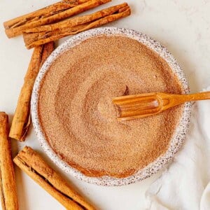 cinnamon sugar in a bowl with a wooden spoon