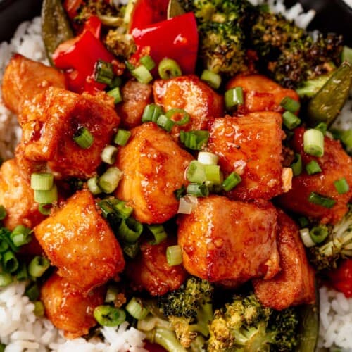 air fryer salmon bites on a bed of rice with broccoli and scallions.