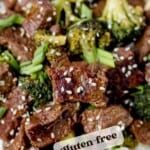 quick and easy instant pot mongolian beef that's gluten-free on a dinner plate with rice, broccoli and sesame seeds