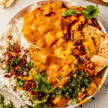 mango chicken curry with rice, naan, and cilantro