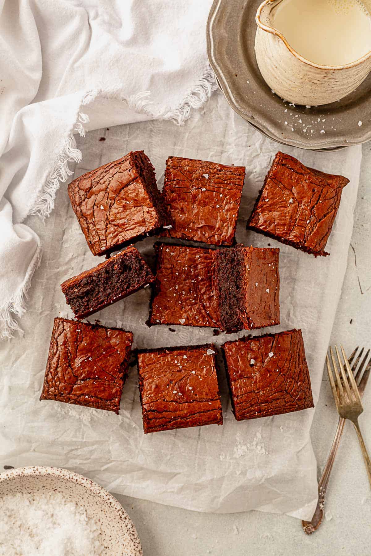 paleo brownies cut into squares on parchment paper