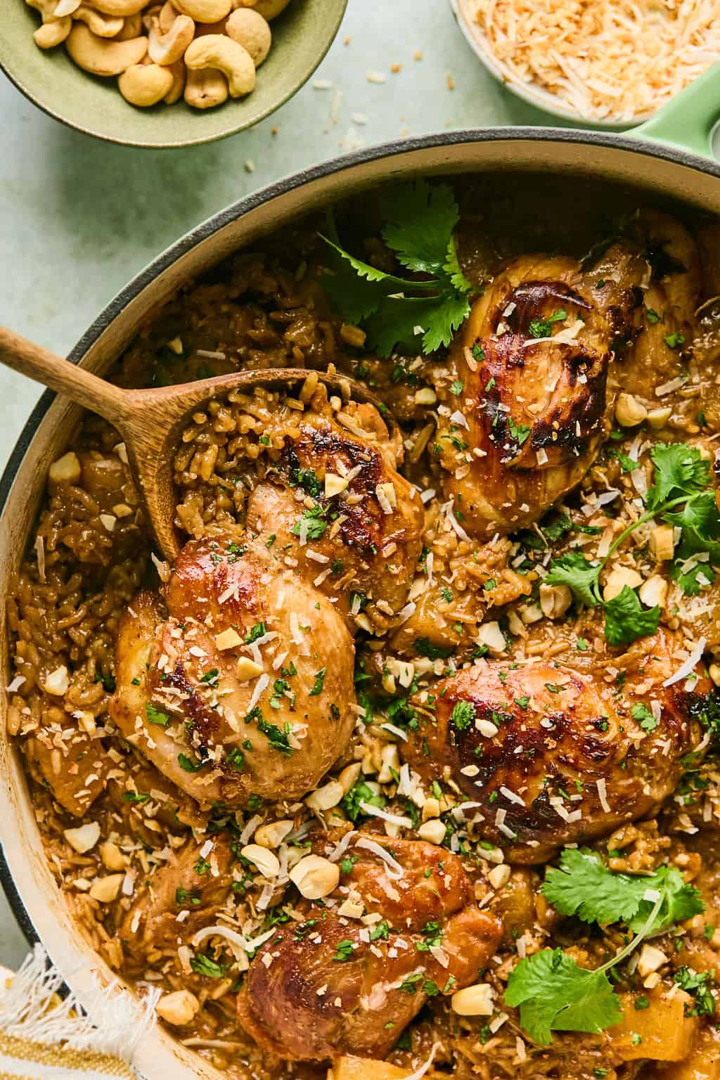 a spoon in a skillet of hawaiian chicken and rice.