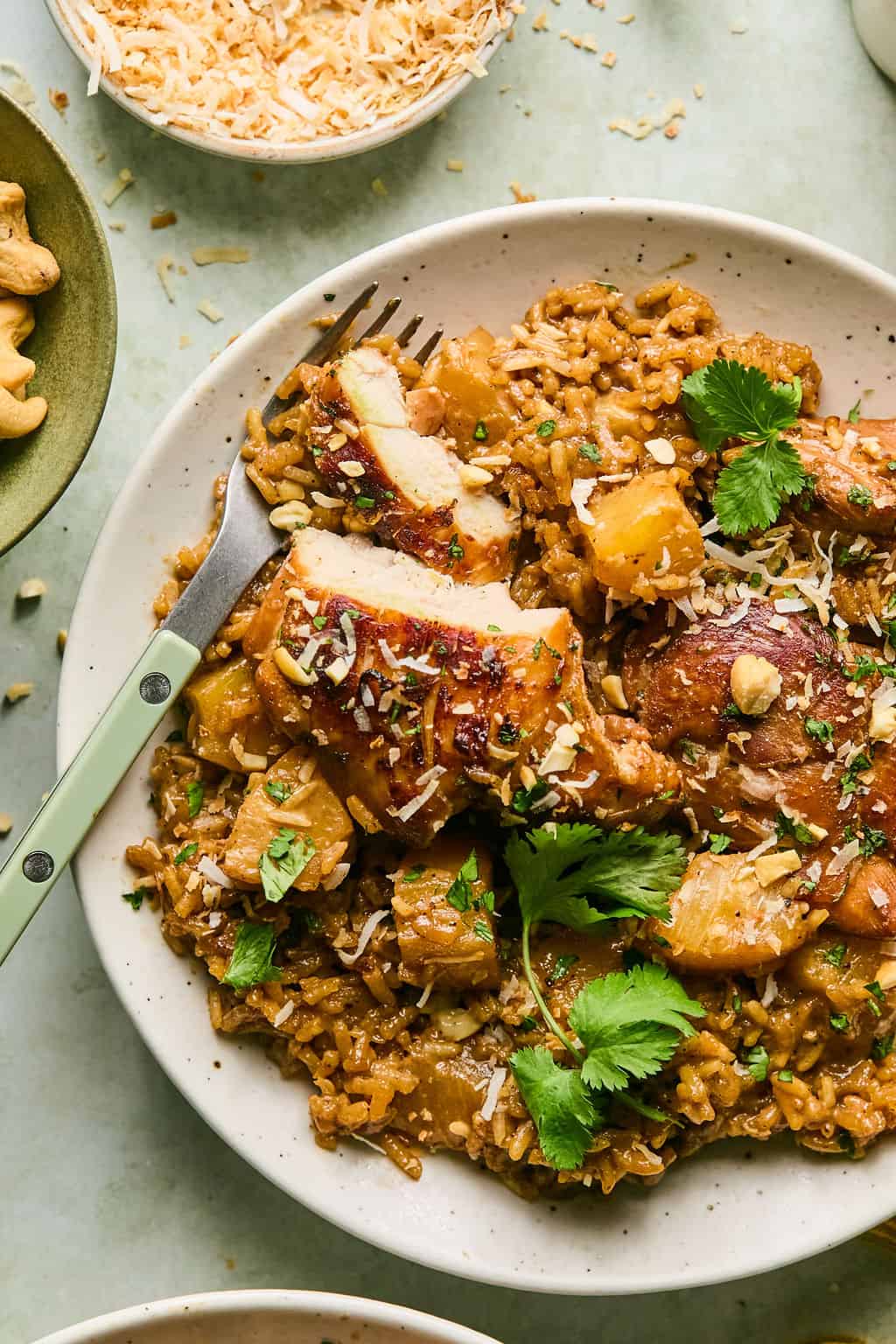 a plate of hawaiian chicken and rice with a fork.