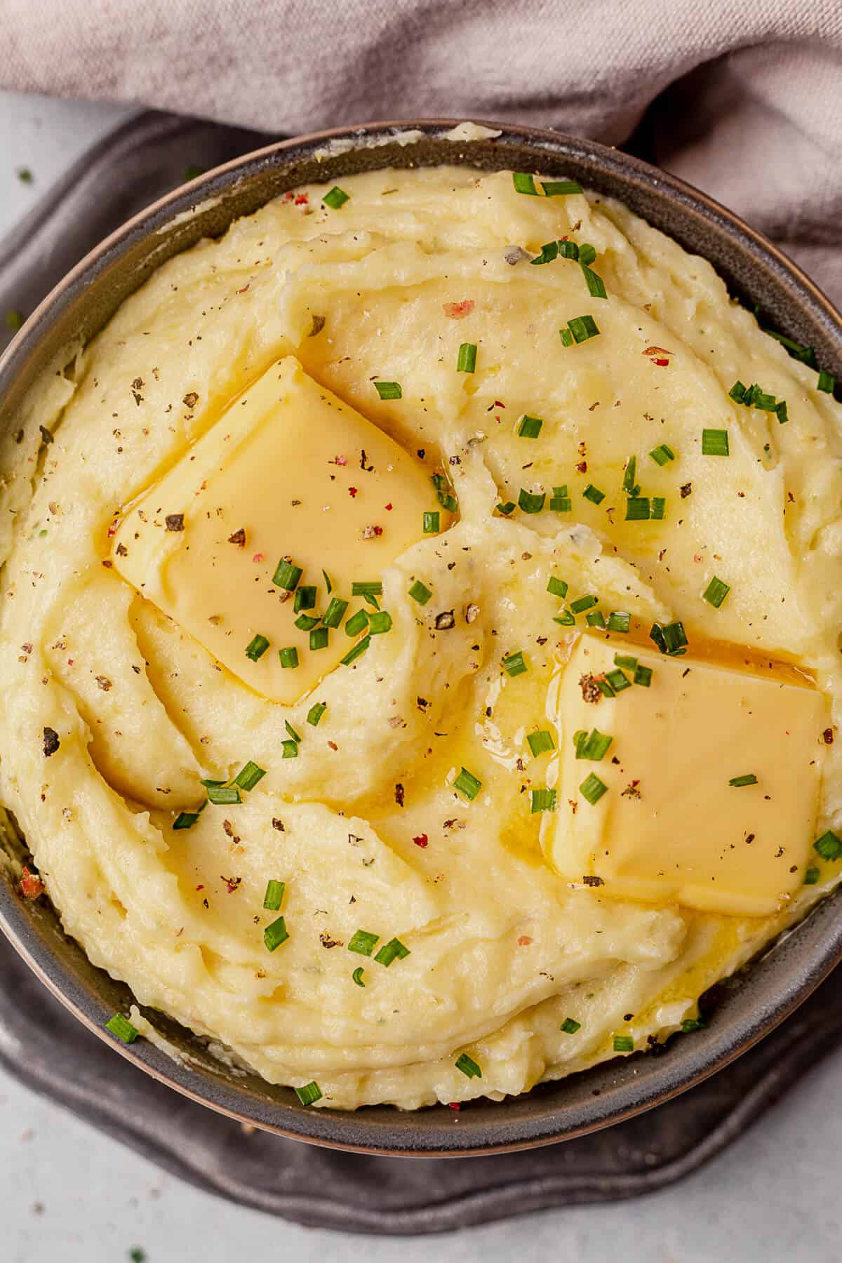 melted butter and chives on top of boursin mashed potatoes