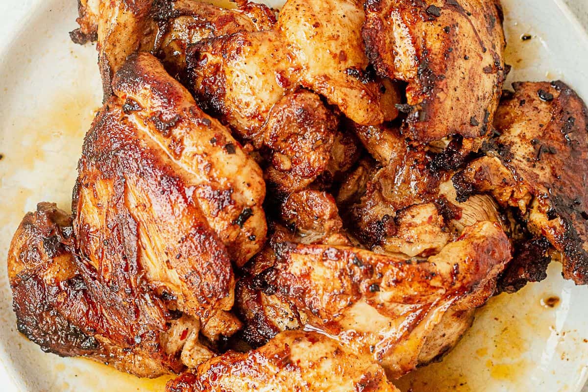 seared and golden brown honey harissa chicken thighs on a plate