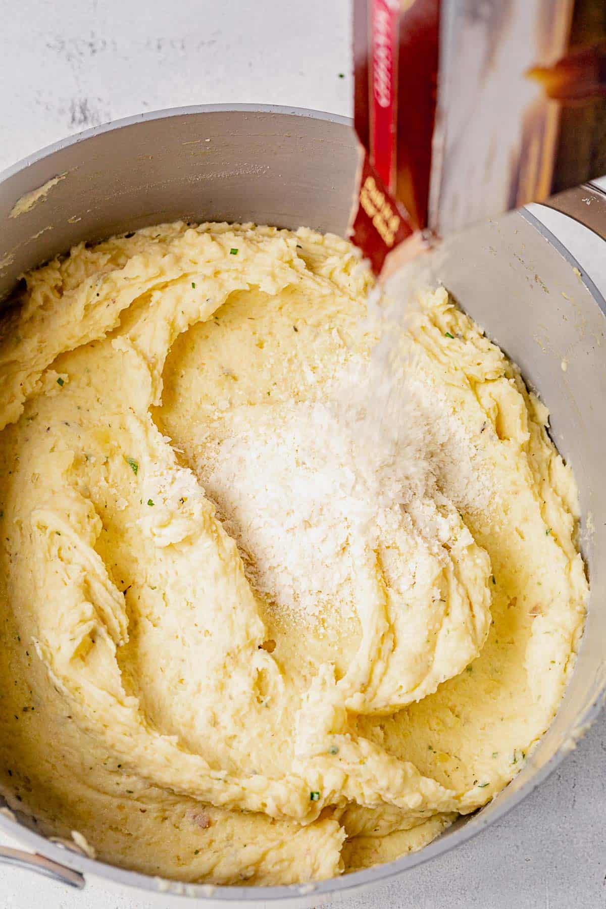 pouring dehydrated potatoes into mashed potatoes