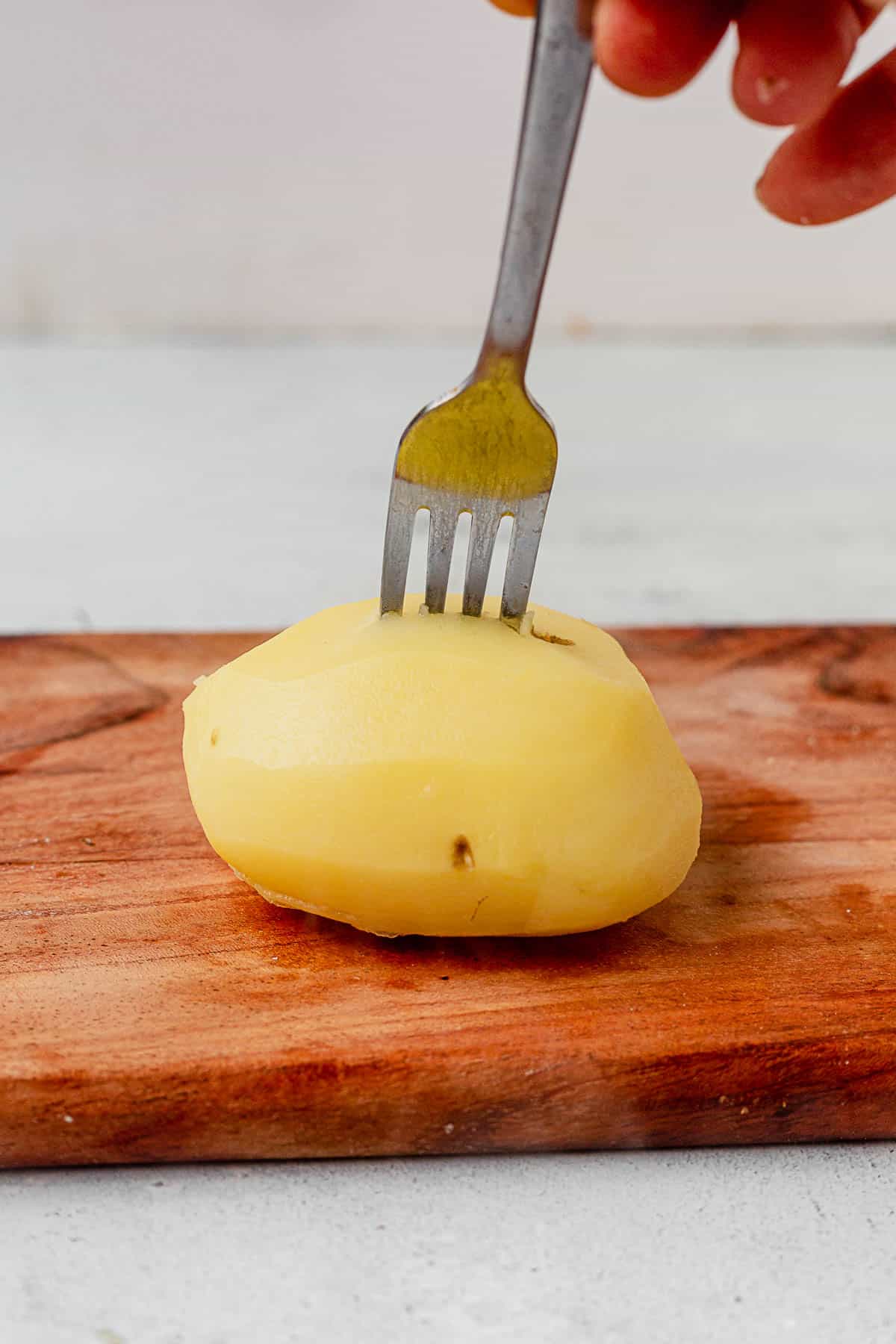 piercing a potato with a fork