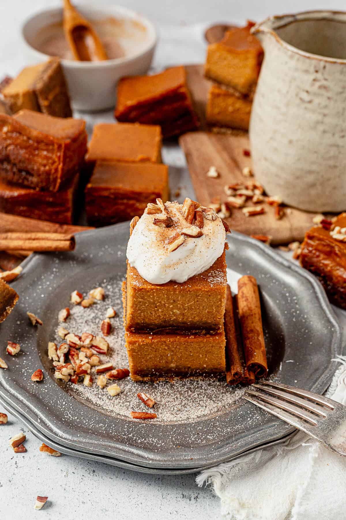 pumpkin pie bars on a plate with cinnamon sugar