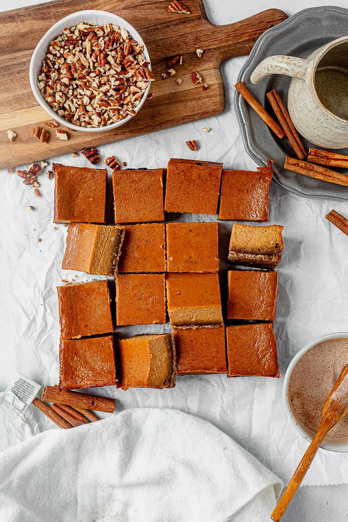 16 pumpkin pie bars on parchment paper