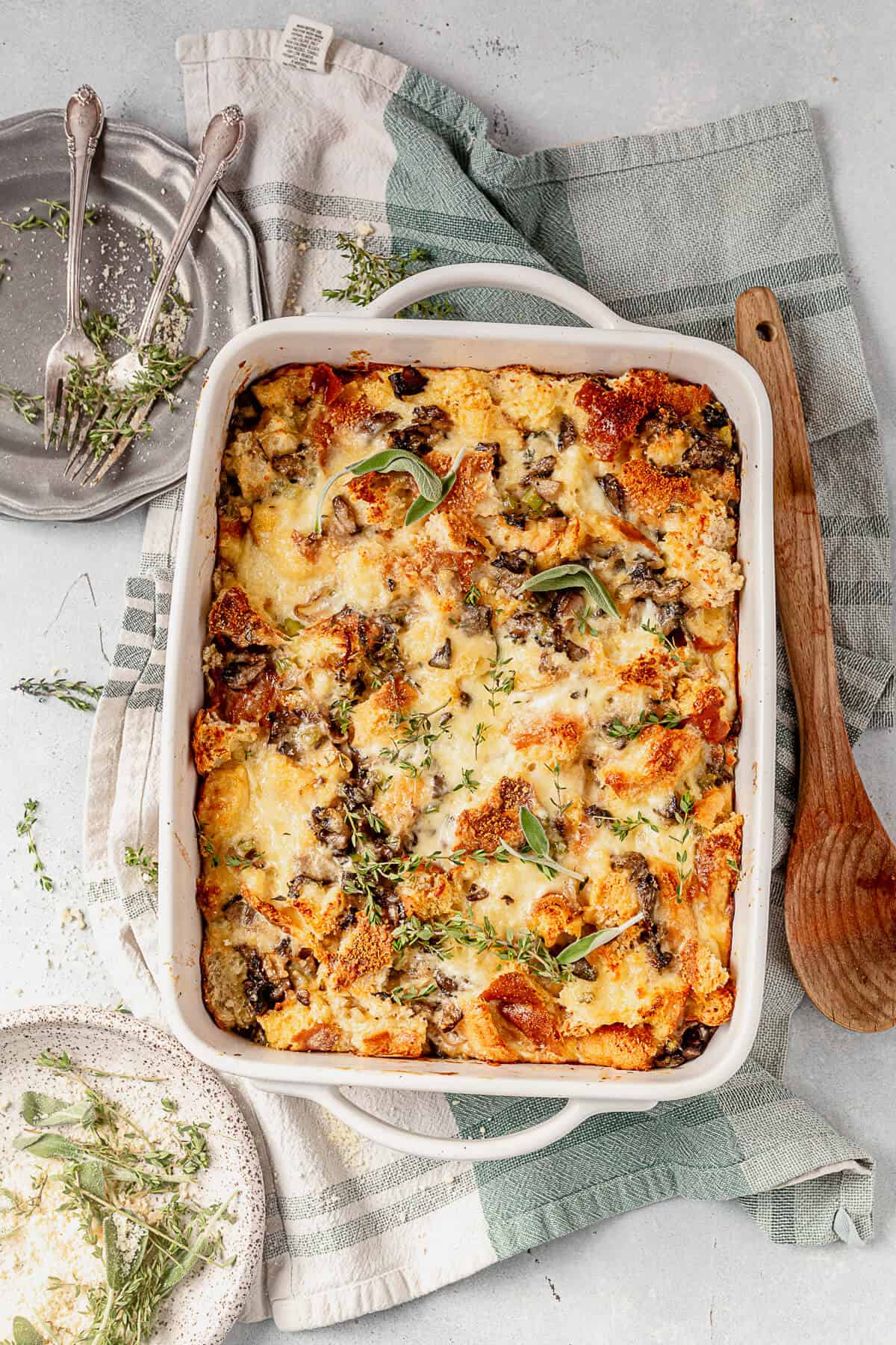 9x13 inch casserole dish of savory bread pudding with rosemary and sage on top