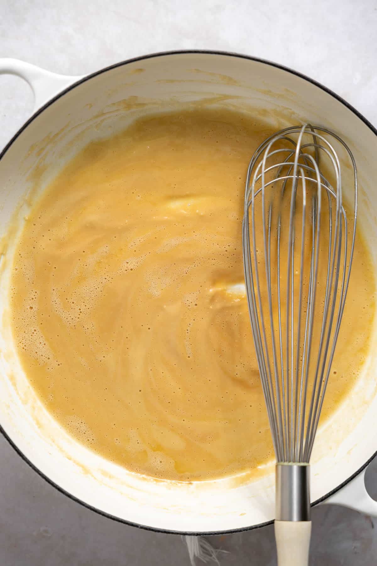 whisking a roux in a saucepan.