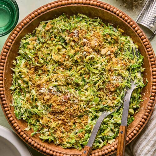 brussels sprout caesar salad in a wooden salad bowl.
