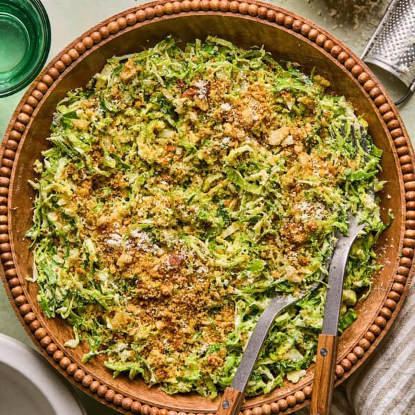 brussels sprout caesar salad in a wooden salad bowl.