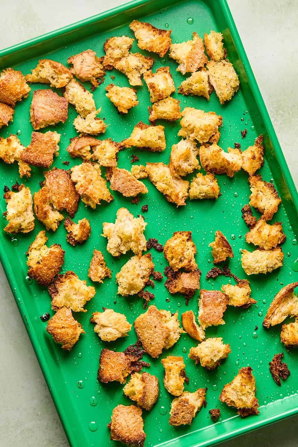 toasted sourdough croutons on a baking sheet.