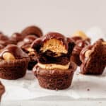 two stacked buckeye cookies with a bite missing from the top one