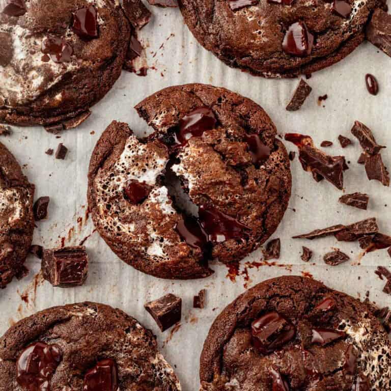 A batch of chocolate marshmallow cookies on a cookie sheet.