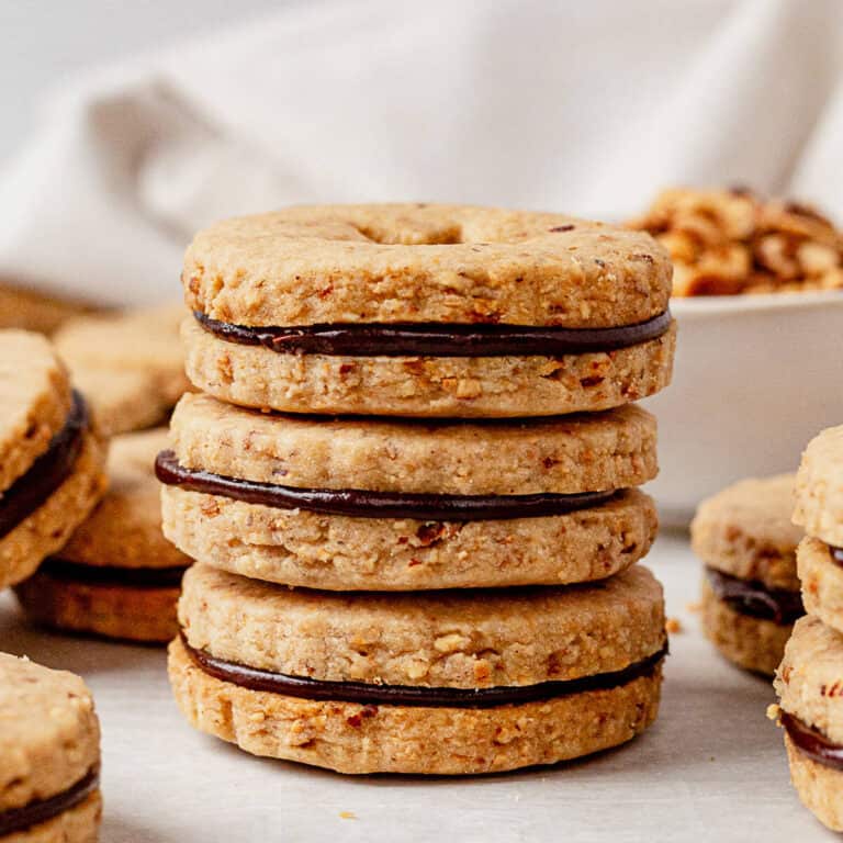 three hazelnut shortbread cookies stacked on a cookie sheet