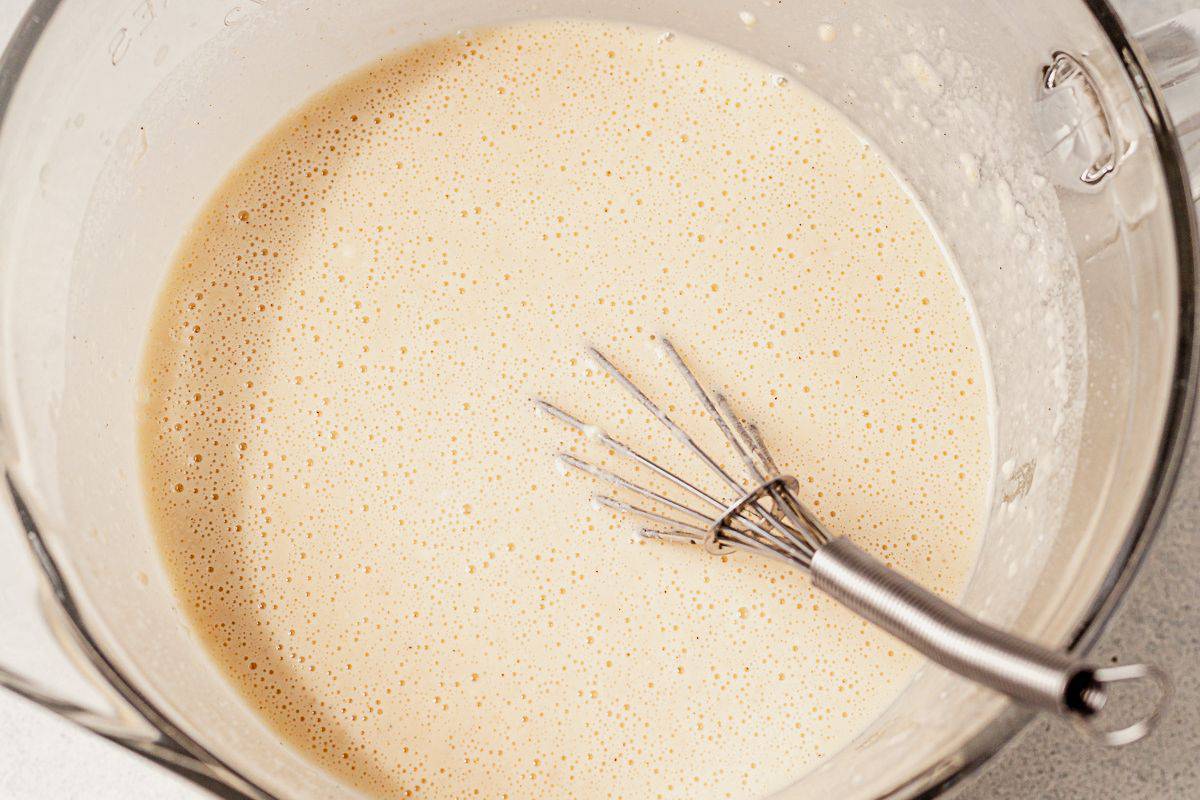 pancake batter in a bowl with a whisk