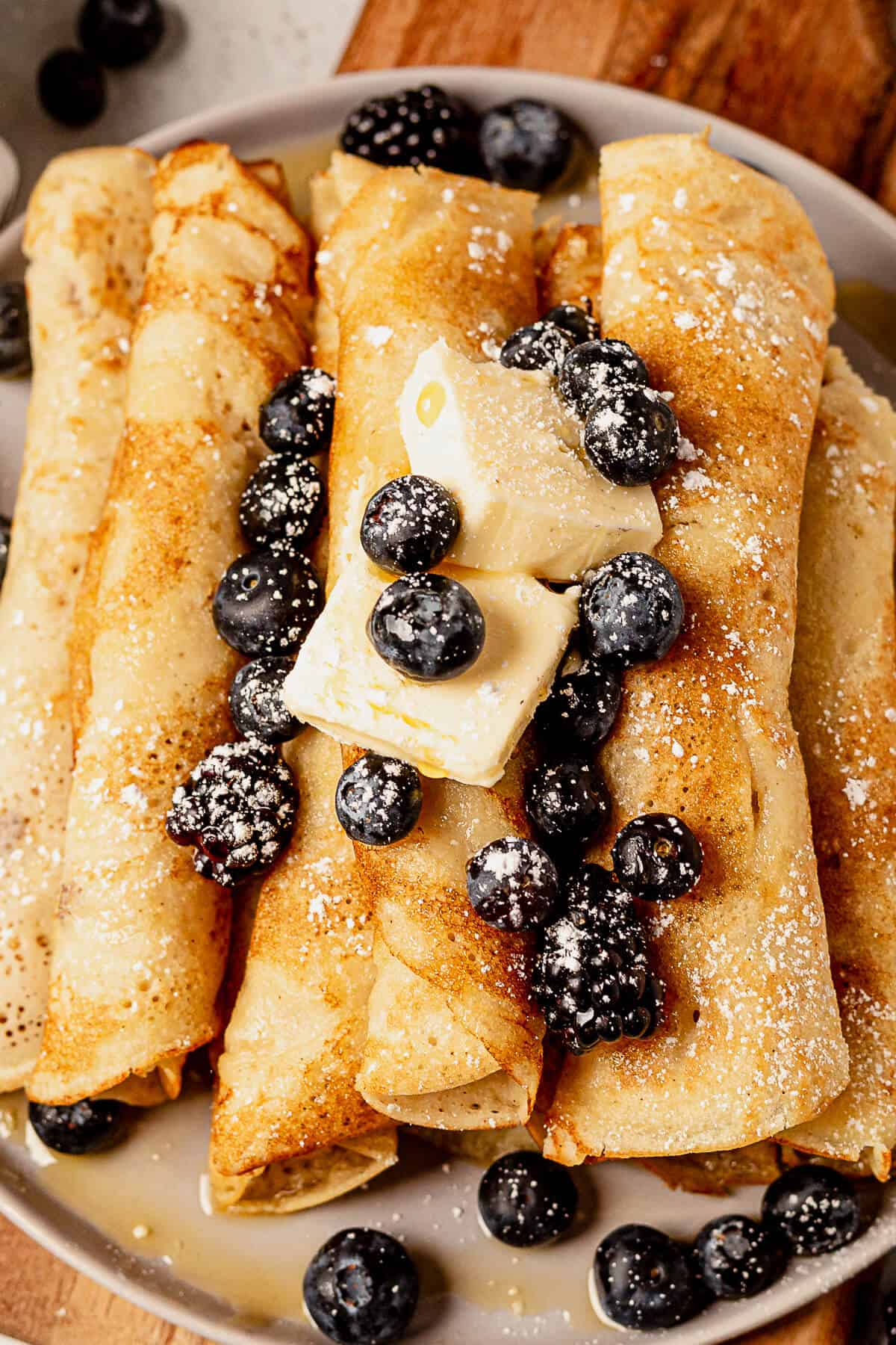 pancake roll ups with berries, butter, and syrup