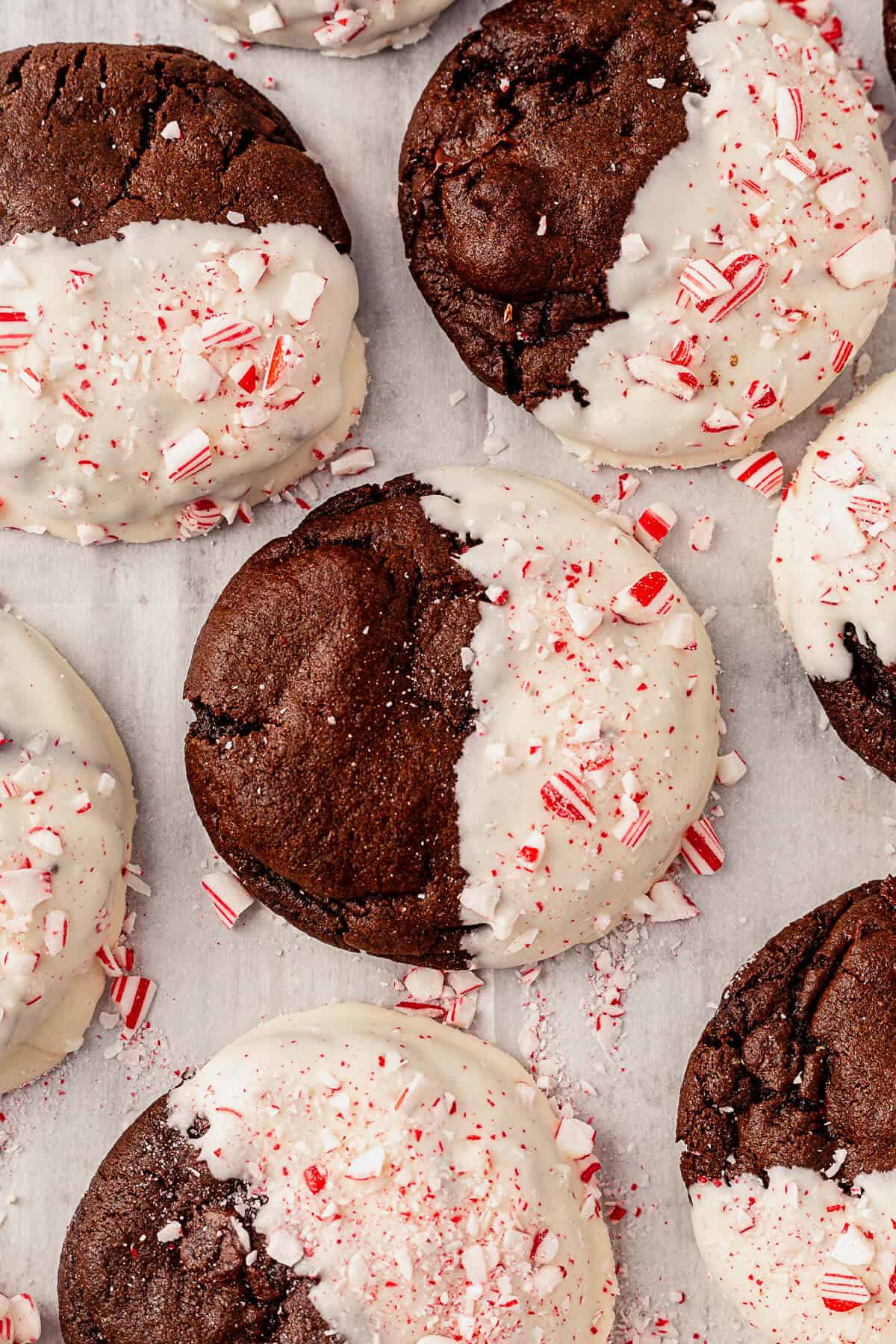 peppermint bark cookies with white chocolate and peppermint on a parchment lined cookie sheet