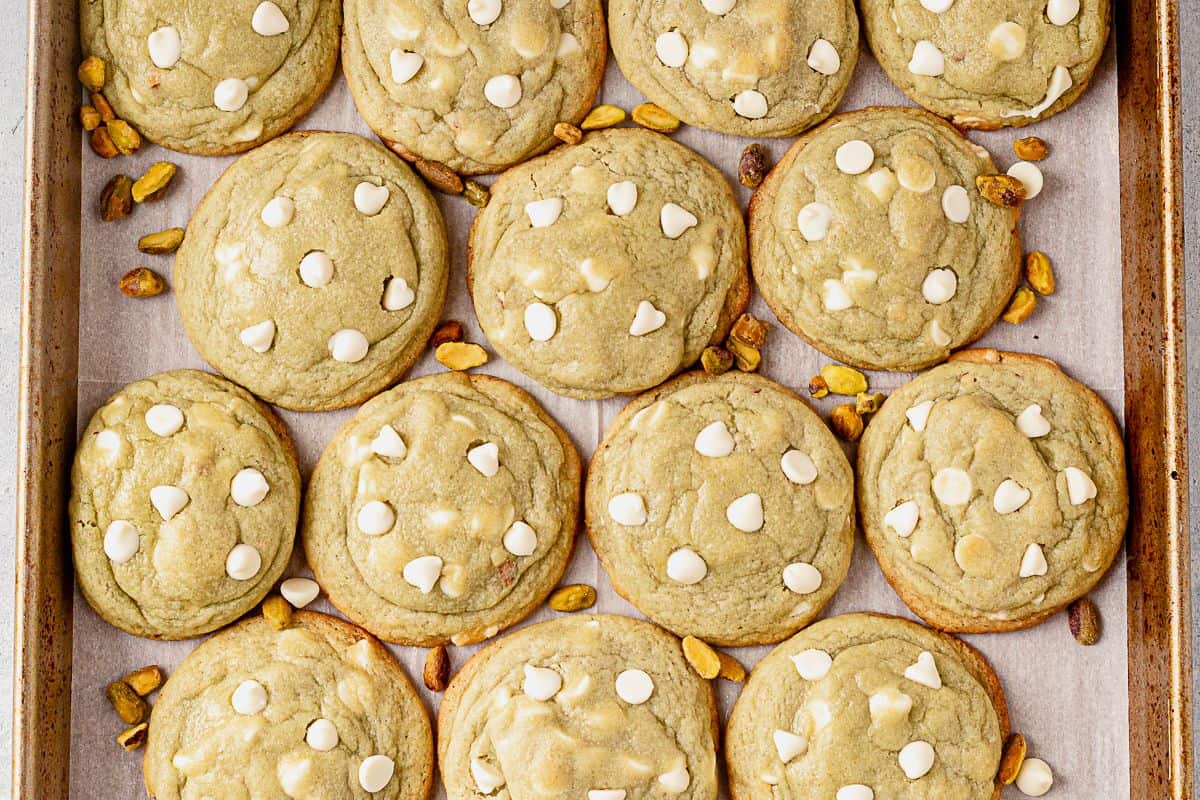 a cookie sheet of freshly baked pistachio pudding cookies