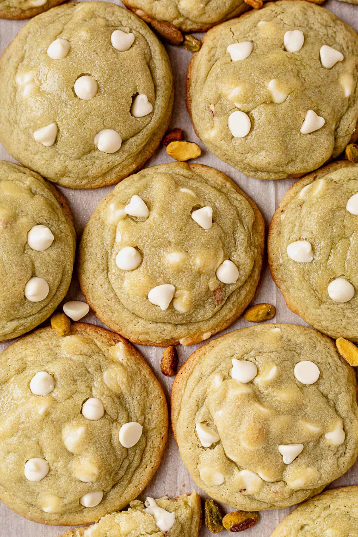 pistachio pudding cookies with white chocolate chips on parchment paper