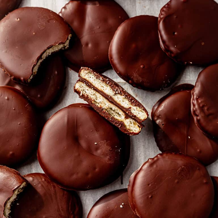 a ritz thin mint broken in half in a pile of more ritz thin mint cookies