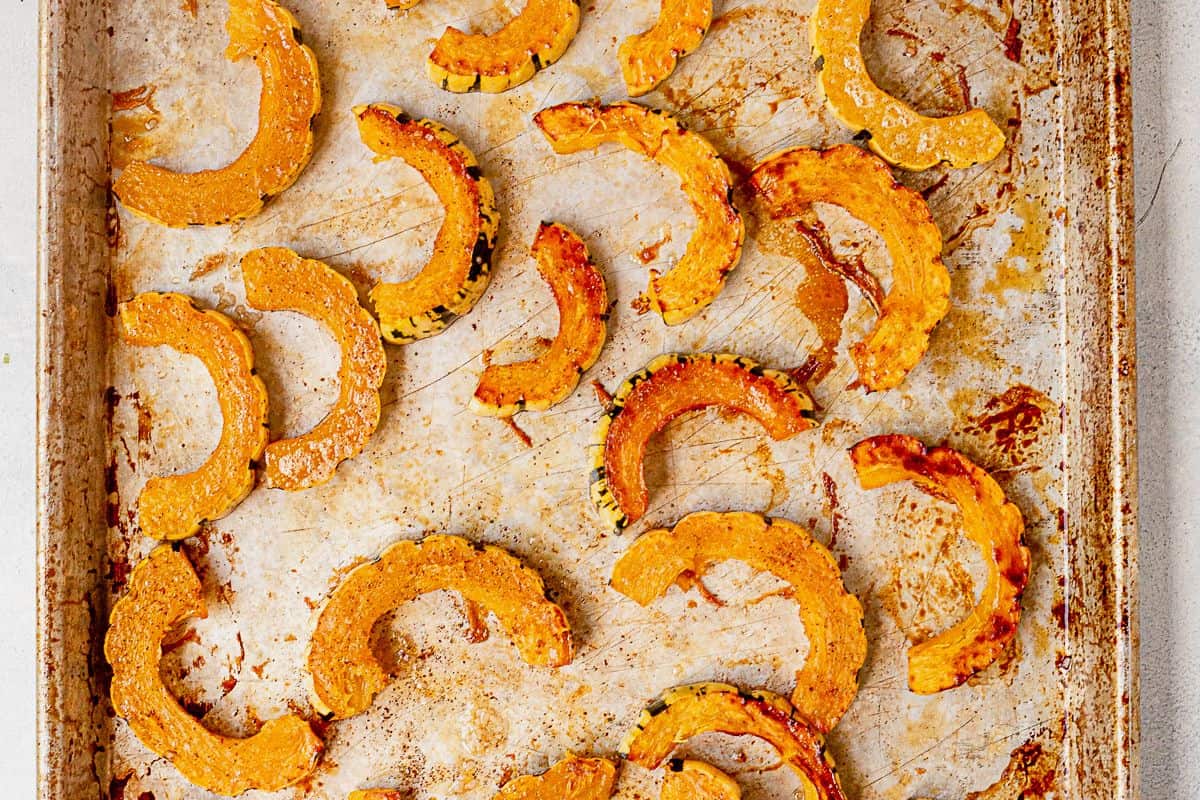 roasted golden brown delicata squash on a sheet pan