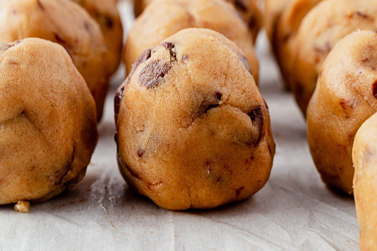 salted caramel chocolate chip cookie dough on a parchment baking sheet