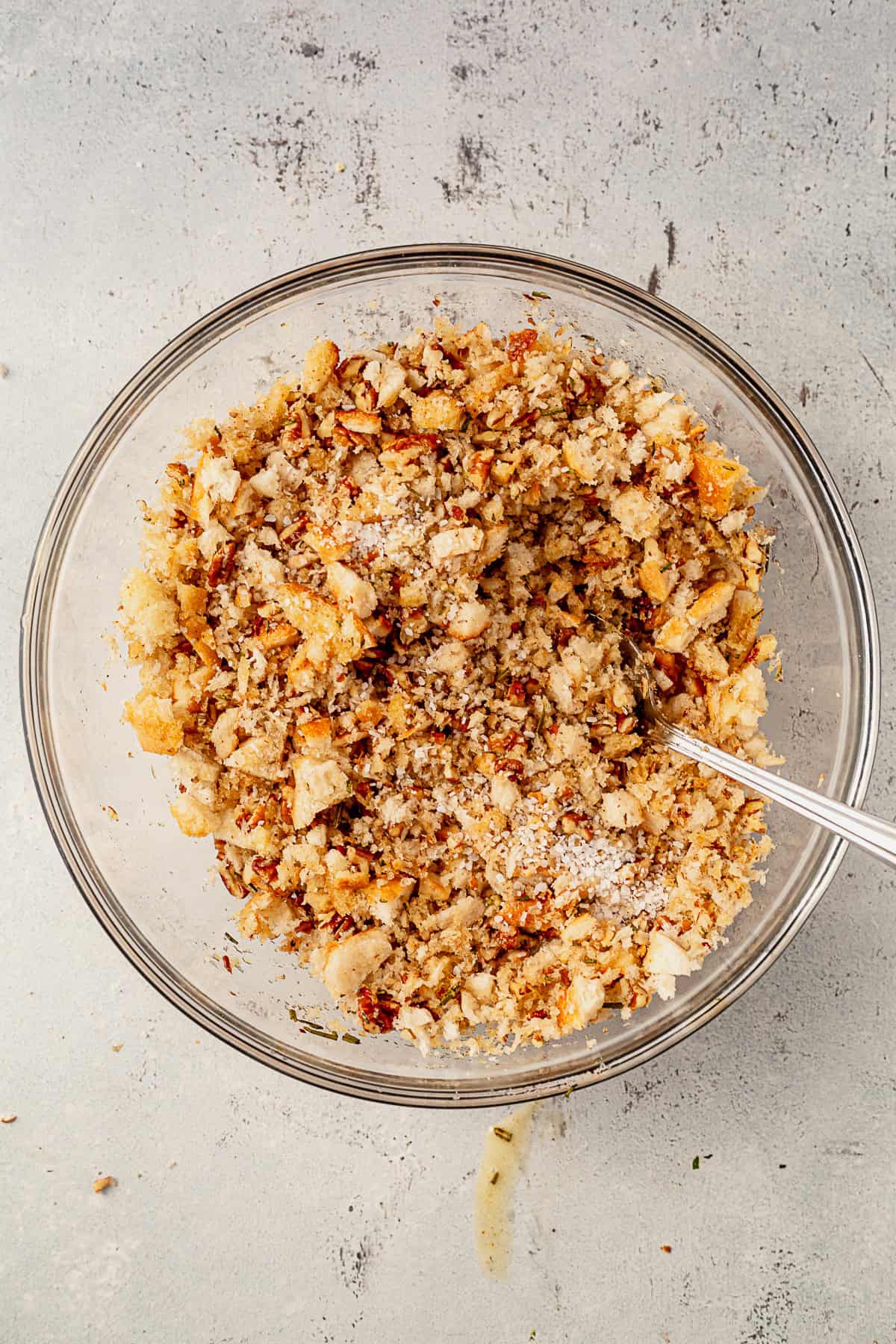 sourdough pecan breadcrumbs in a bowl with butter and rosemary.