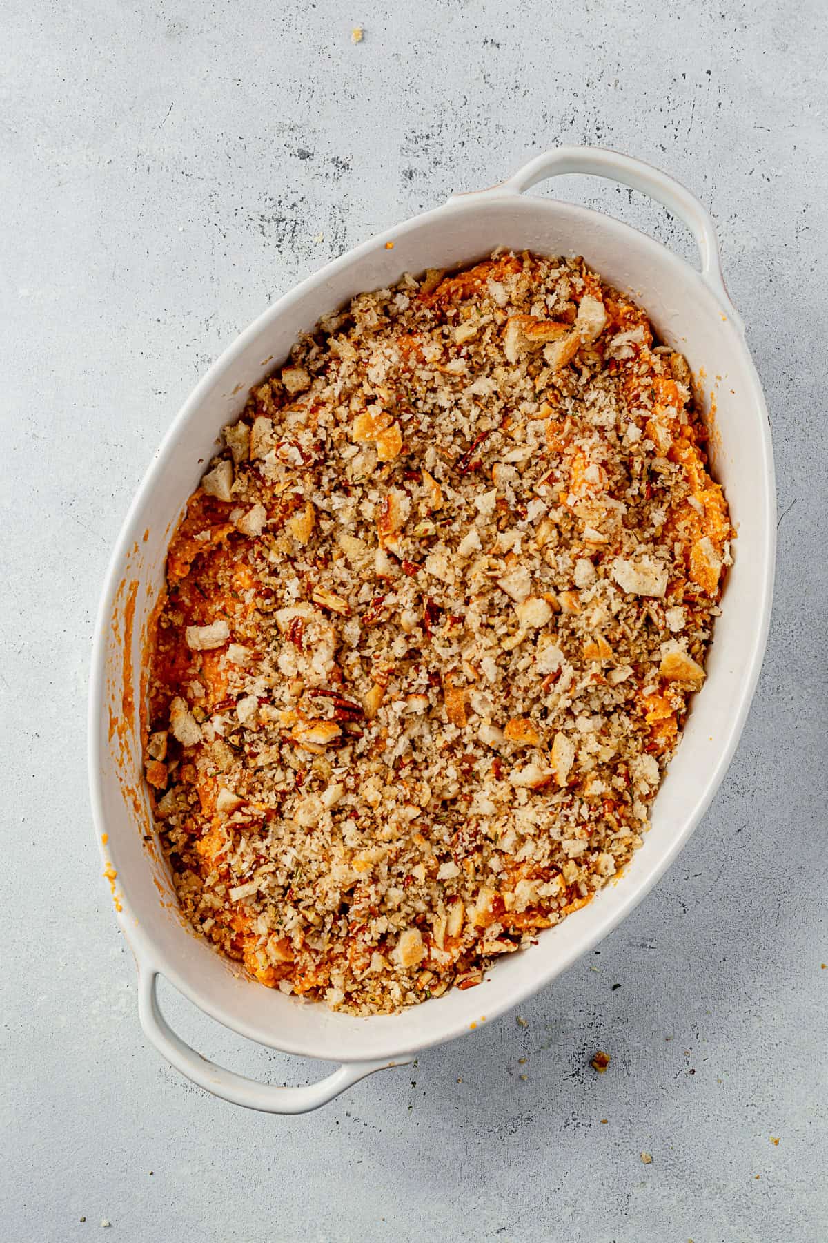 savory sweet potato casserole in a baking dish before cooking.