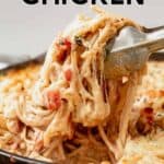 tongs grabbing spaghetti chicken out of cast iron skillet