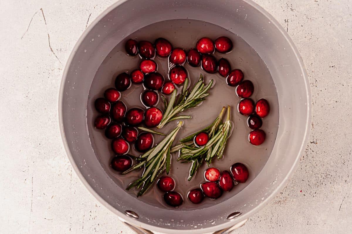 fresh cranberries and rosemary in simple syrup