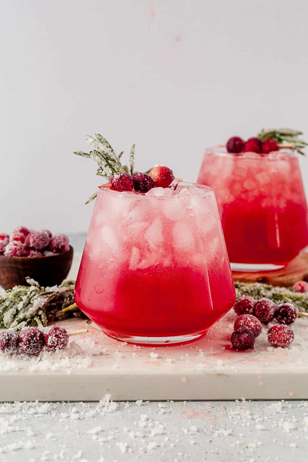 cranberry christmas paloma with rosemary simple syrup on a countertop
