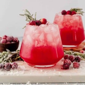 christmas paloma in a with sugared cranberries and rosemary