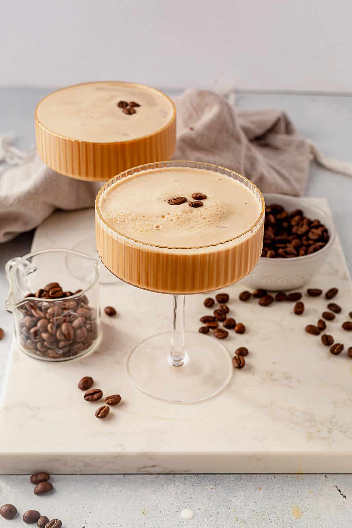 two creamy espresso martinis on a serving tray