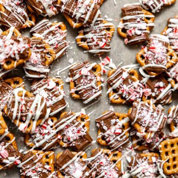 peppermint pretzels with milk and white chocolate on a cookie sheet.