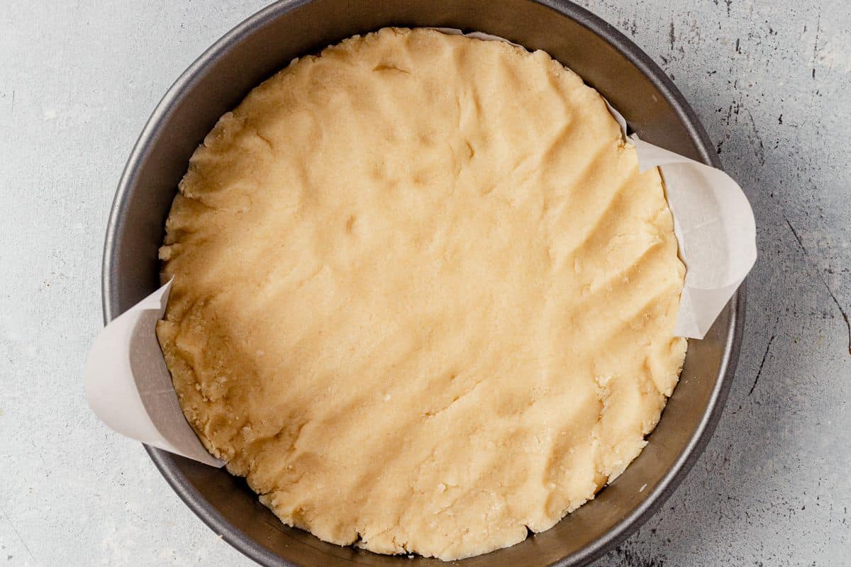 almond shortbread cookie dough pressed into a cake pan
